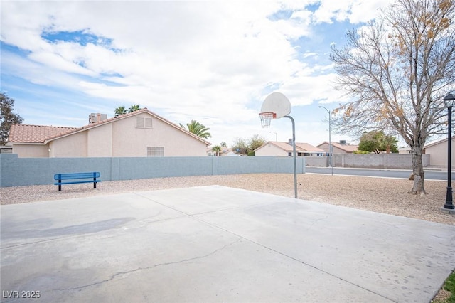 view of sport court featuring community basketball court and fence private yard