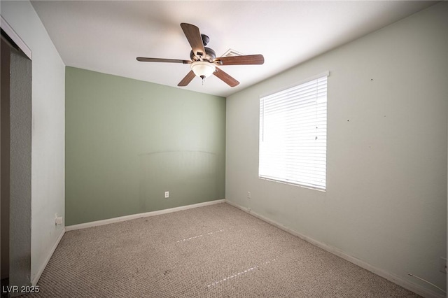 spare room featuring baseboards, ceiling fan, and carpet flooring