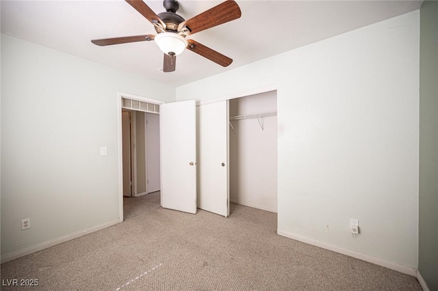 unfurnished bedroom with carpet, baseboards, a closet, and ceiling fan