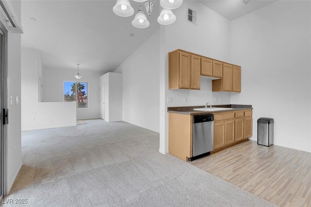 kitchen with visible vents, decorative light fixtures, light colored carpet, dishwasher, and a towering ceiling