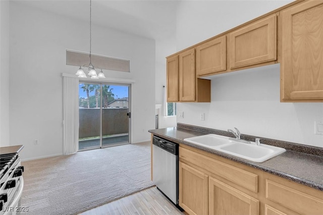 kitchen featuring dark countertops, a sink, light brown cabinetry, and stainless steel dishwasher