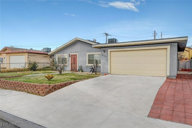 single story home featuring stucco siding, driveway, fence, a garage, and central AC unit