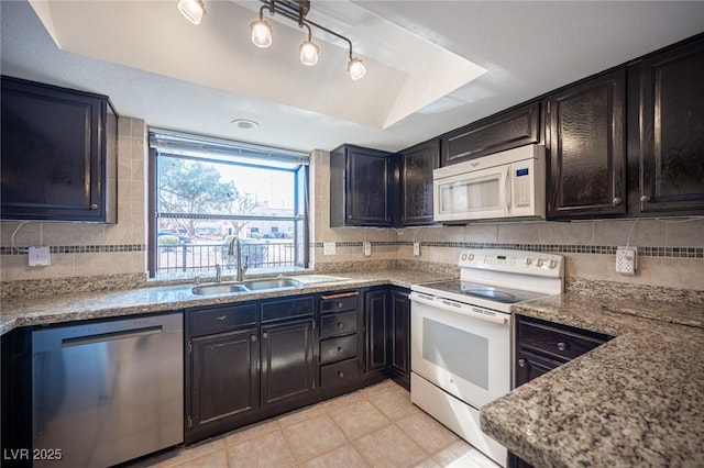 3369 Milenko Dr, Las Vegas, NV 89121 - kitchen featuring white appliances, a sink, backsplash, light tile patterned floors, and light stone countertops