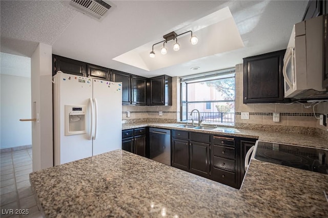 3369 Milenko Dr, Las Vegas, NV 89121 - kitchen with a sink, white appliances, tasteful backsplash, tile patterned floors, and a peninsula