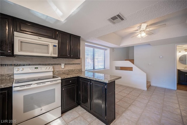 3369 Milenko Dr, Las Vegas, NV 89121 - kitchen with white appliances, light tile patterned floors, light stone counters, a ceiling fan, and a peninsula