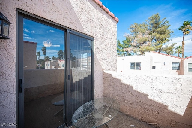 3369 Milenko Dr, Las Vegas, NV 89121 - view of side of home featuring a balcony and stucco siding