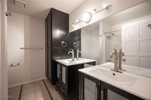 3369 Milenko Dr, Las Vegas, NV 89121 - bathroom with tile patterned flooring, baseboards, and two vanities