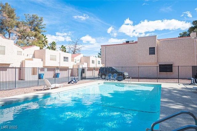 pool with a residential view and fence