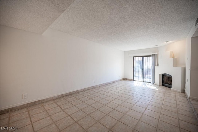 3369 Milenko Dr, Las Vegas, NV 89121 - unfurnished living room with a textured ceiling, a fireplace, baseboards, and tile patterned flooring