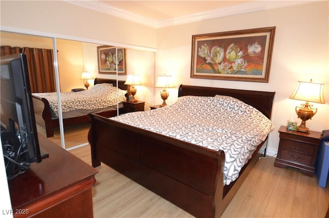 bedroom with a closet, light wood-type flooring, and ornamental molding