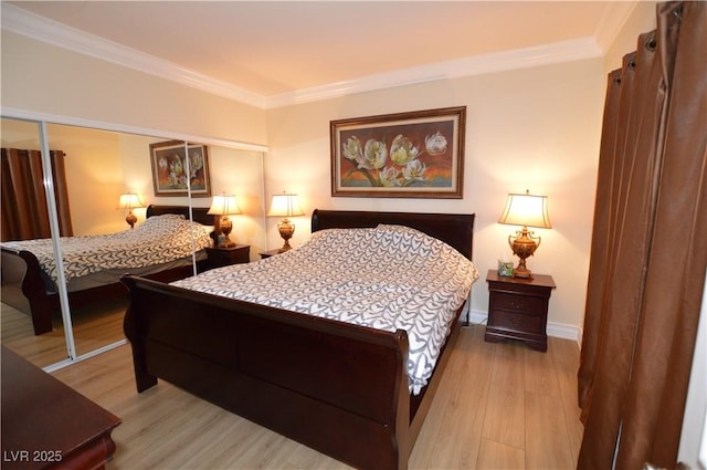 bedroom with baseboards, ornamental molding, and light wood finished floors