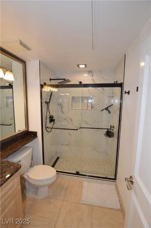 bathroom with vanity, toilet, visible vents, and a marble finish shower