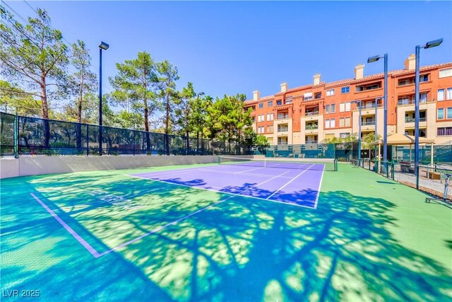 view of sport court featuring fence