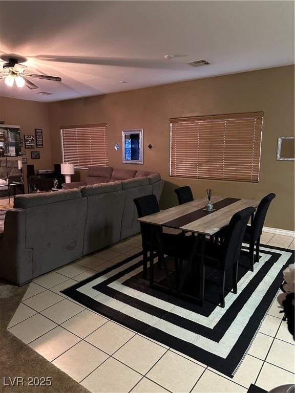 dining room featuring light tile patterned floors, visible vents, and a ceiling fan