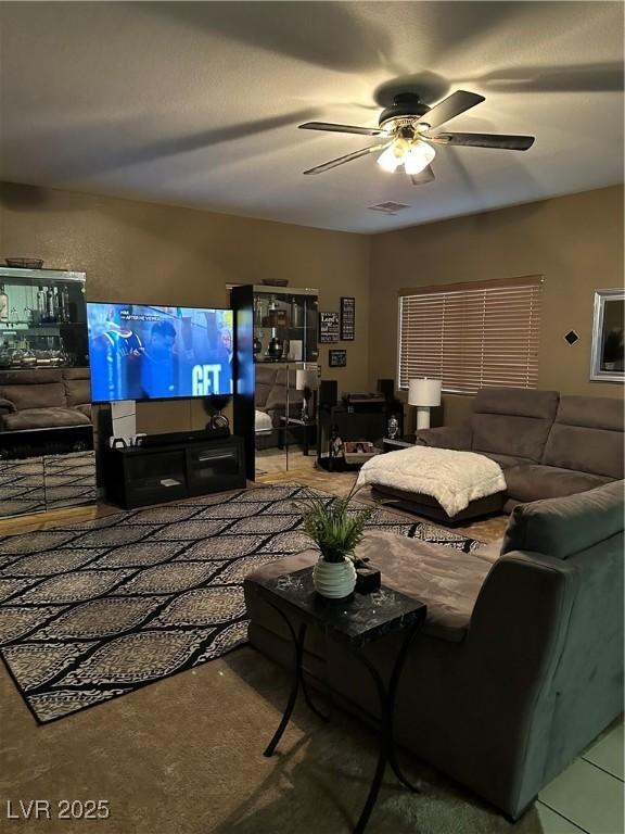 living area with visible vents and a ceiling fan