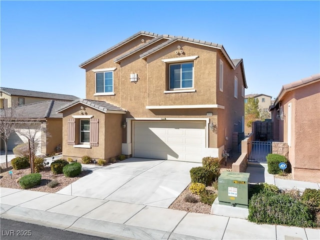 view of front of home with concrete driveway, a garage, a tile roof, and stucco siding