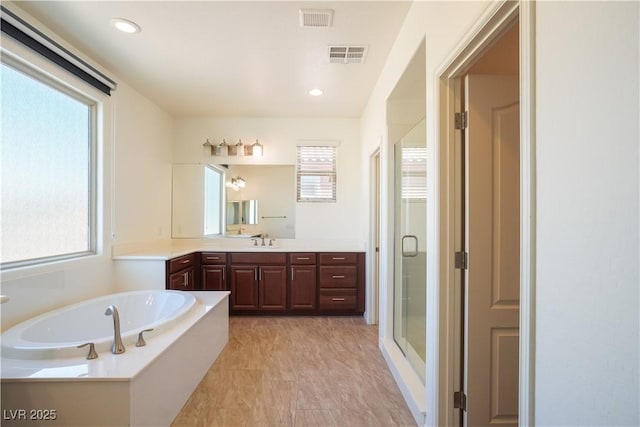 bathroom with a healthy amount of sunlight, visible vents, and a stall shower