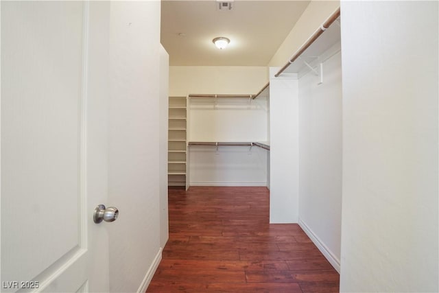 spacious closet featuring visible vents and wood finished floors