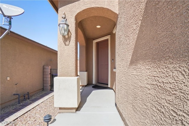 property entrance with stucco siding