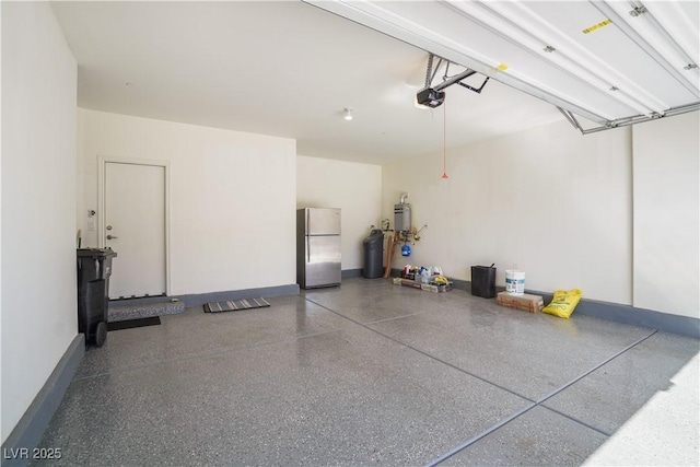 garage featuring a garage door opener, freestanding refrigerator, and baseboards