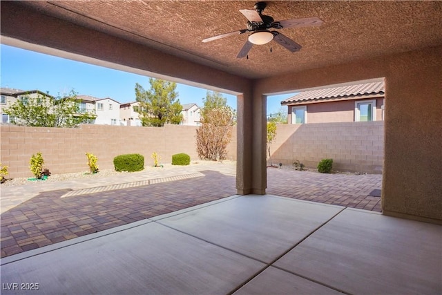 view of patio featuring ceiling fan, a residential view, and a fenced backyard