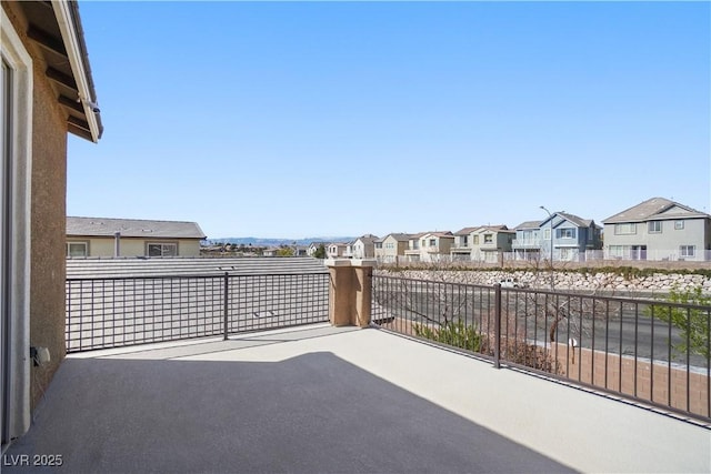 view of patio with a residential view and a balcony