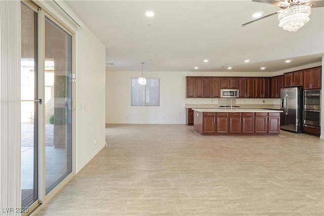 kitchen with a center island with sink, open floor plan, recessed lighting, stainless steel appliances, and light countertops