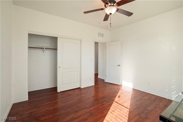 unfurnished bedroom with a closet, baseboards, visible vents, and wood-type flooring