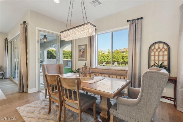 dining area featuring baseboards, visible vents, and light wood-type flooring