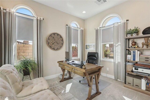 office area featuring carpet flooring, baseboards, and visible vents