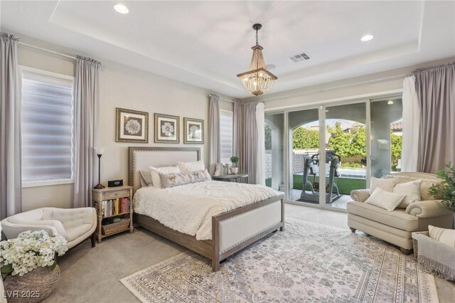 carpeted bedroom featuring recessed lighting, visible vents, a raised ceiling, and access to exterior