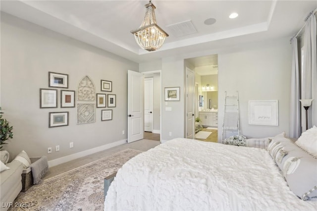 carpeted bedroom with visible vents, an inviting chandelier, baseboards, and a tray ceiling