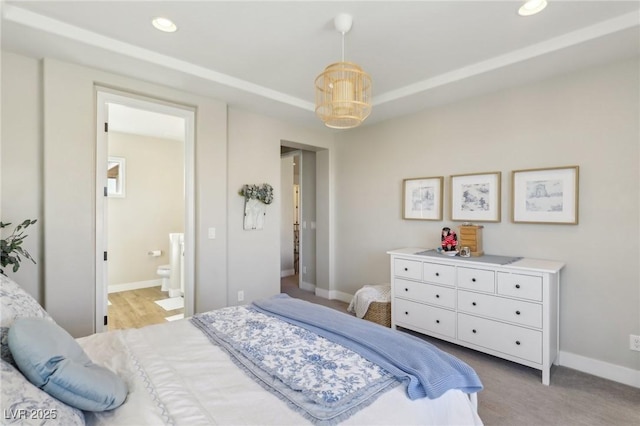 bedroom featuring recessed lighting, ensuite bath, and baseboards