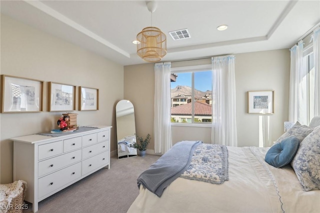 bedroom featuring light carpet, visible vents, recessed lighting, and a raised ceiling