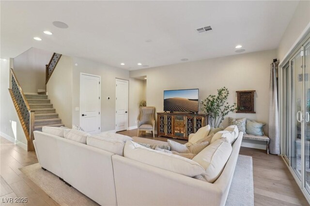 living room with recessed lighting, stairway, visible vents, and light wood-style flooring