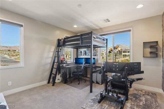 bedroom with multiple windows, baseboards, visible vents, and carpet floors