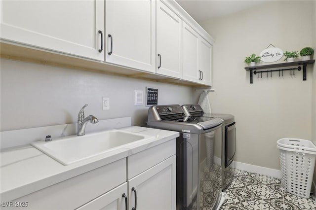 washroom with a sink, cabinet space, light tile patterned floors, baseboards, and washing machine and clothes dryer