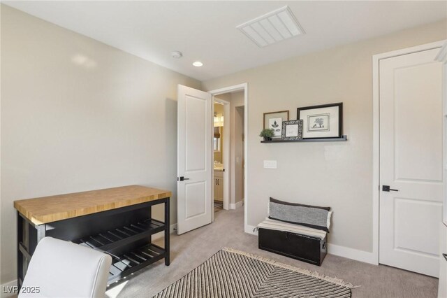 interior space with recessed lighting, light colored carpet, visible vents, and baseboards