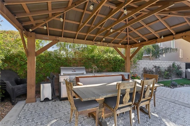 view of patio with a gazebo, area for grilling, outdoor dining area, and fence