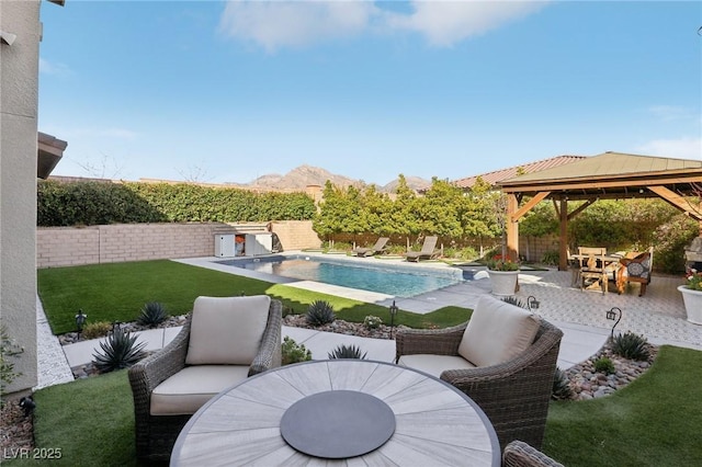 view of swimming pool featuring a fenced backyard, a gazebo, outdoor dining area, a fenced in pool, and a patio area