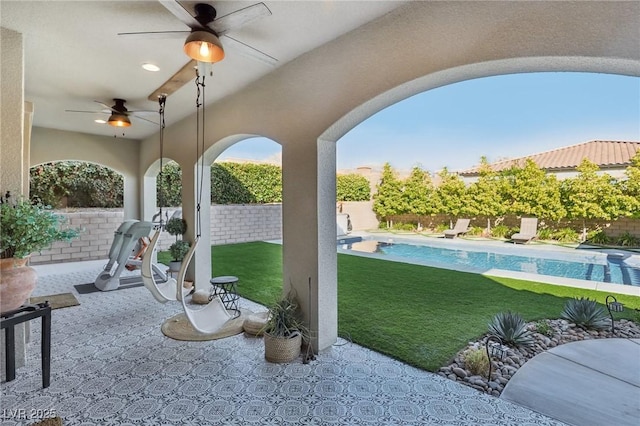 view of patio with a fenced in pool, a fenced backyard, and a ceiling fan