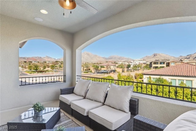 balcony with a residential view, an outdoor hangout area, and a ceiling fan