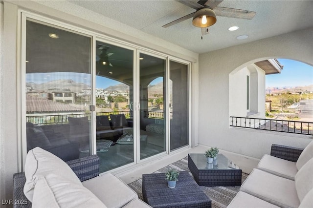 balcony featuring an outdoor living space and a ceiling fan