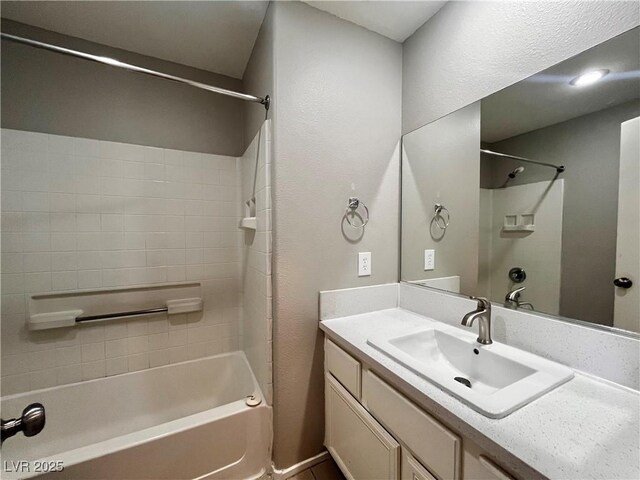 bathroom featuring vanity and  shower combination