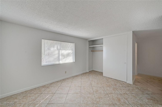 unfurnished bedroom with a closet, a textured ceiling, and tile patterned flooring