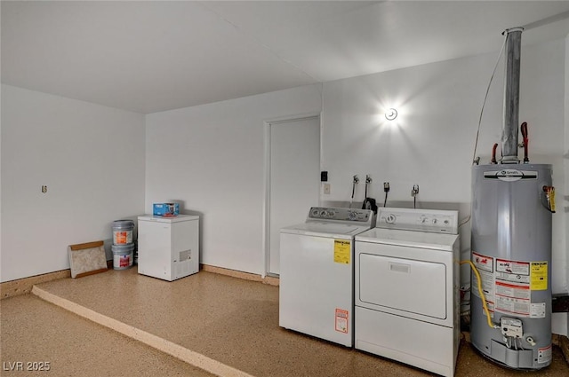 washroom with water heater, washer and dryer, and baseboards