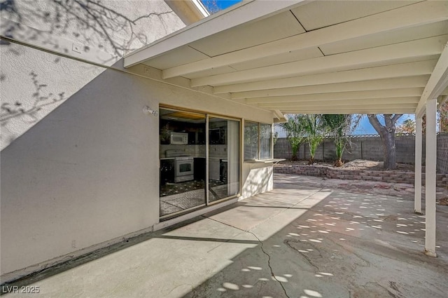 view of patio / terrace featuring fence