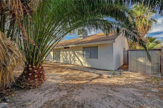 exterior space featuring fence and stucco siding