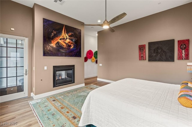 bedroom featuring visible vents, baseboards, and wood finished floors