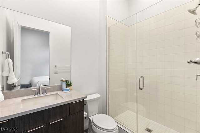 ensuite bathroom featuring a shower stall, ensuite bath, vanity, and toilet